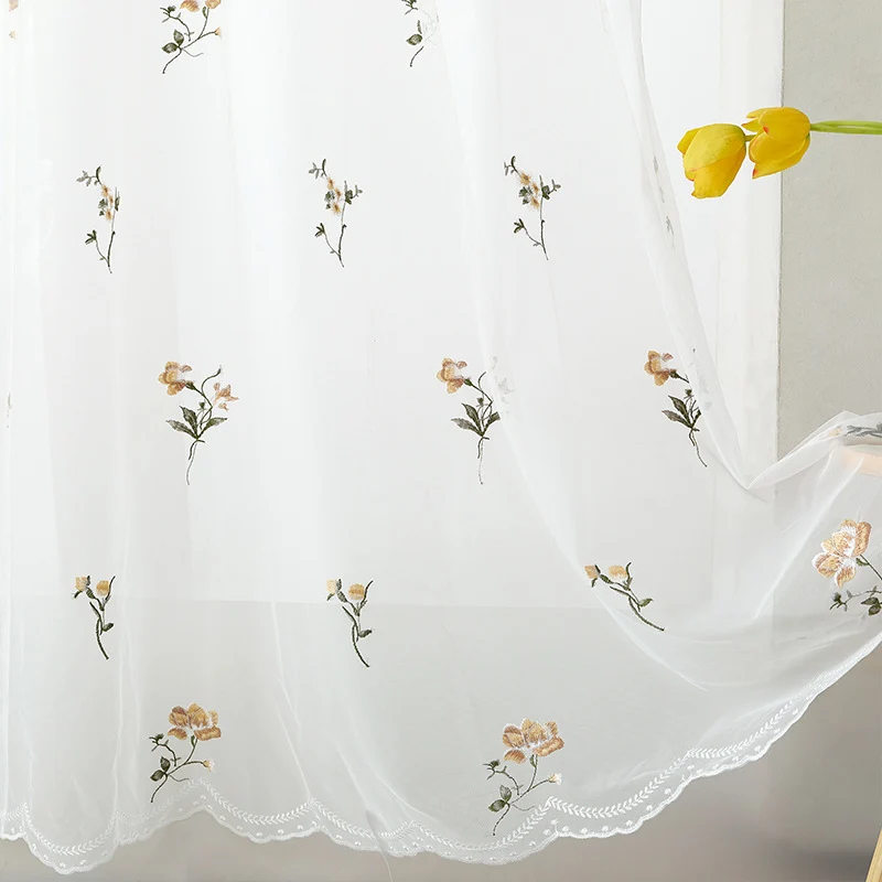 Embroidered sheer curtain panel made of fine tulle with floral embroidery relief and wavy hem Stornfield