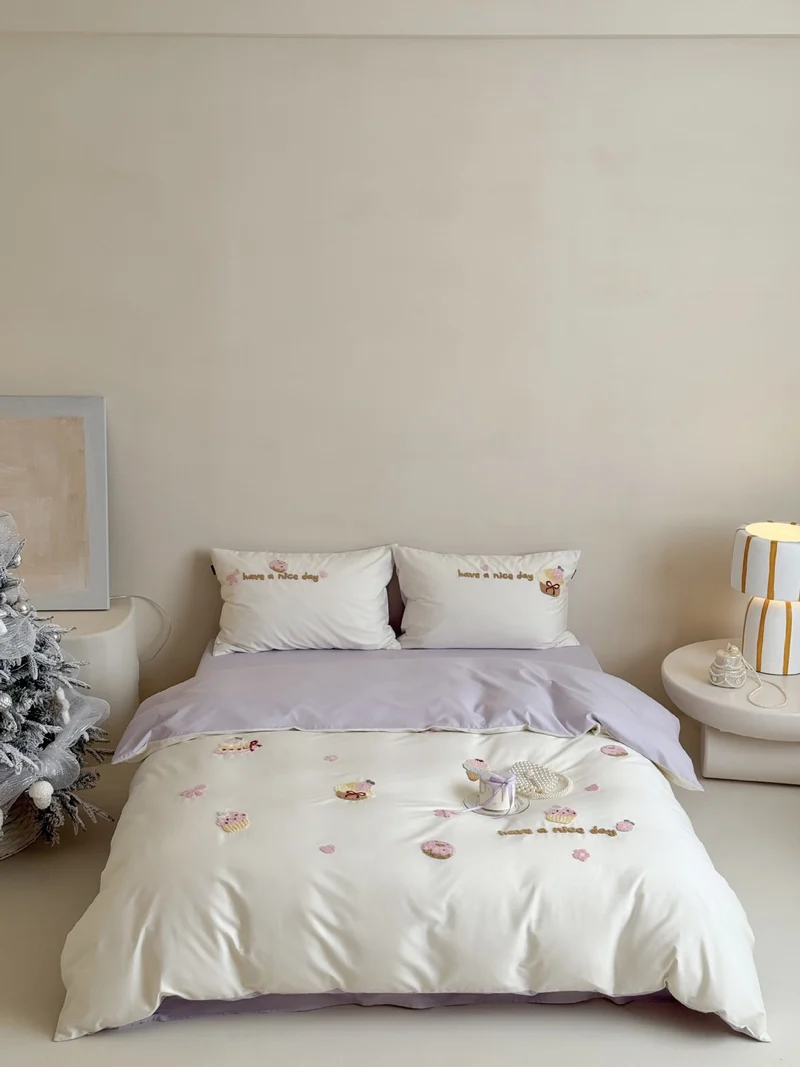 Playful bedding set with embroidered cupcake appliqués and reversible function Stornfield