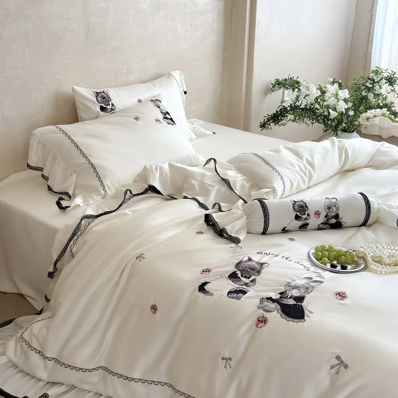 Romantic satin bed linen set with ruffled hem and embroidered animal appliqués Stornfield