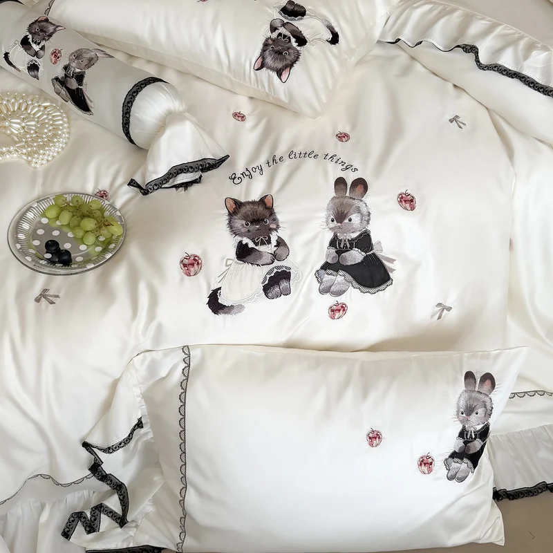 Romantic satin bed linen set with ruffled hem and embroidered animal appliqués Stornfield