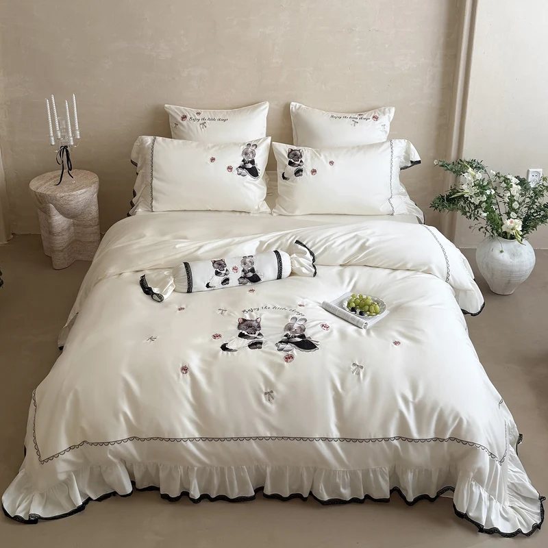 Romantic satin bed linen set with ruffled hem and embroidered animal appliqués Stornfield