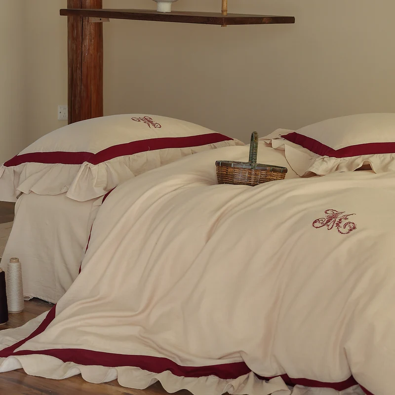 Romantic cotton-linen bedding set with ruffle, monogram embroidery, and contrasting trim Stornfield