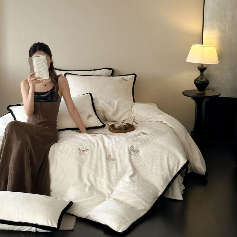 Premium cotton satin bedding set with embroidered butterfly appliqués and contrasting piping Stornfield