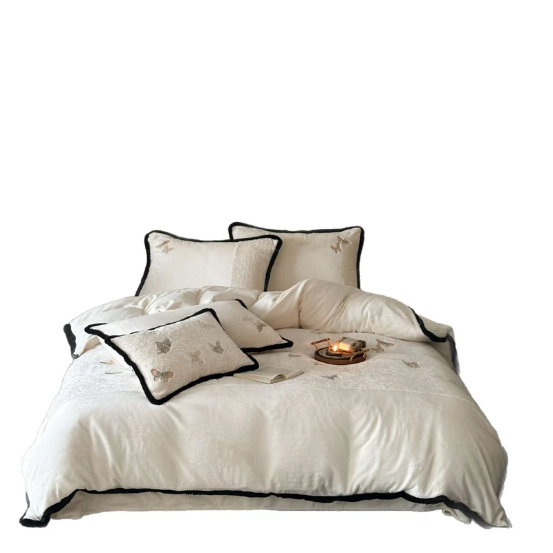 Premium cotton satin bedding set with embroidered butterfly appliqués and contrasting piping Stornfield