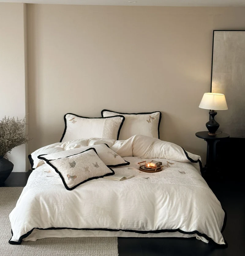 Premium cotton satin bedding set with embroidered butterfly appliqués and contrasting piping Stornfield
