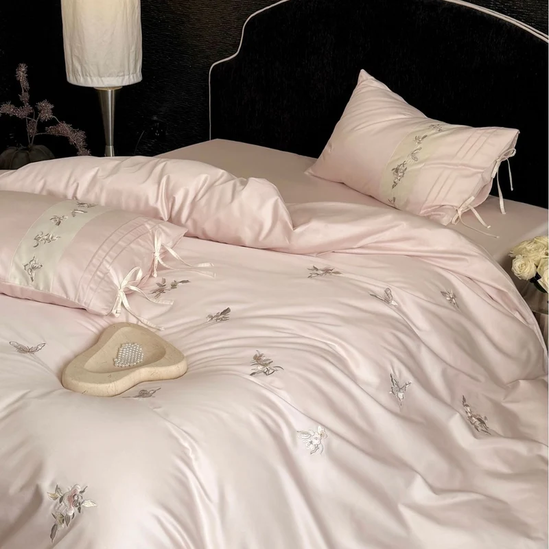 Luxurious satin bedding set with embroidered floral appliqués and bolster Stornfield