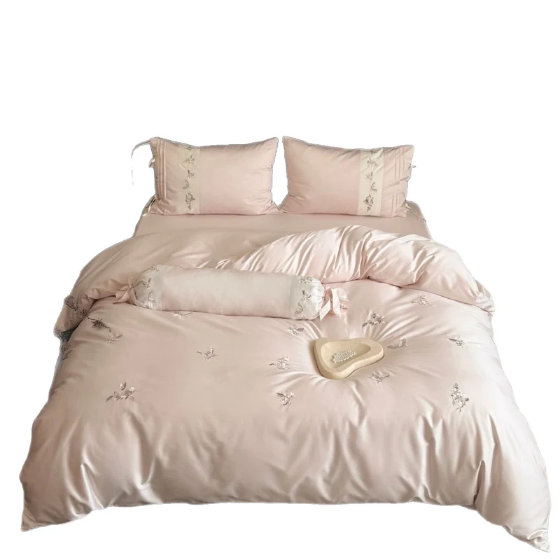 Luxurious satin bedding set with embroidered floral appliqués and bolster Stornfield
