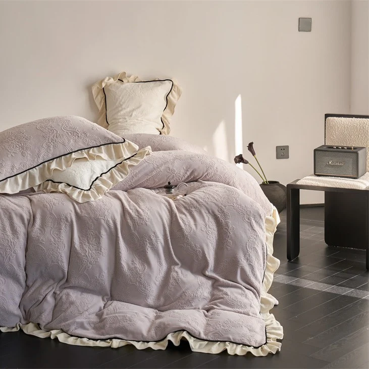 Jacquard bedding set with ruffle, fine floral embossing and contrasting piping Stornfield