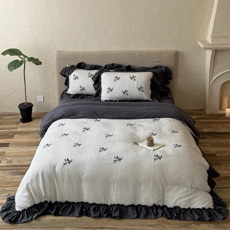 Striped bedding set with fine floral embroidery and ruffled pillowcases Stornfield