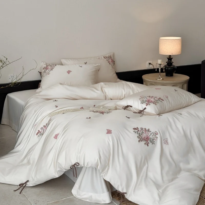 Fine satin bedding set with floral embroidery, tie ribbons and fine quilted texture Stornfield
