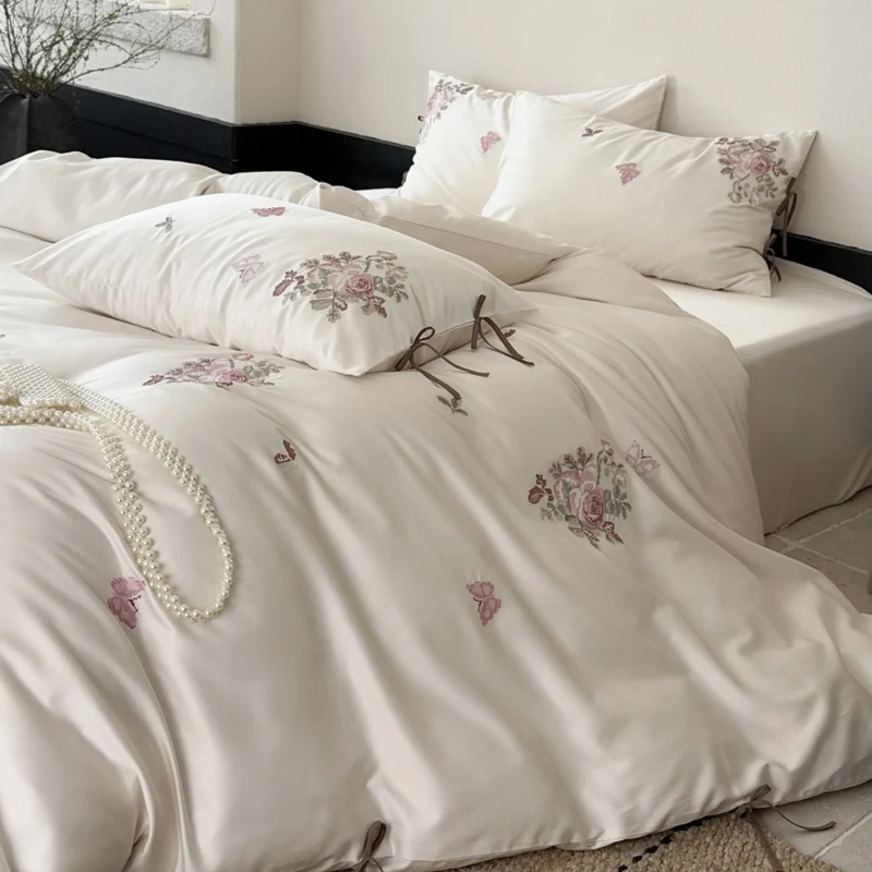 Fine satin bedding set with floral embroidery, tie ribbons and fine quilted texture Stornfield