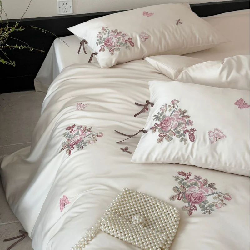 Fine satin bedding set with floral embroidery, tie ribbons and fine quilted texture Stornfield