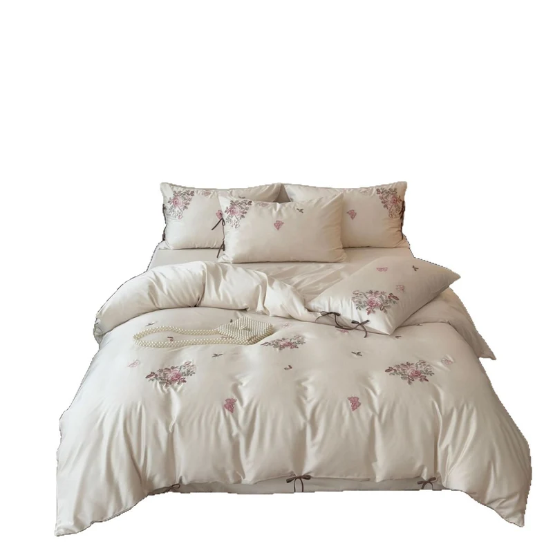Fine satin bedding set with floral embroidery, tie ribbons and fine quilted texture Stornfield