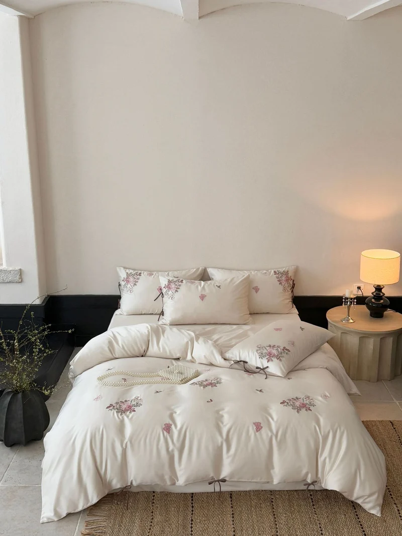 Fine satin bedding set with floral embroidery, tie ribbons and fine quilted texture Stornfield
