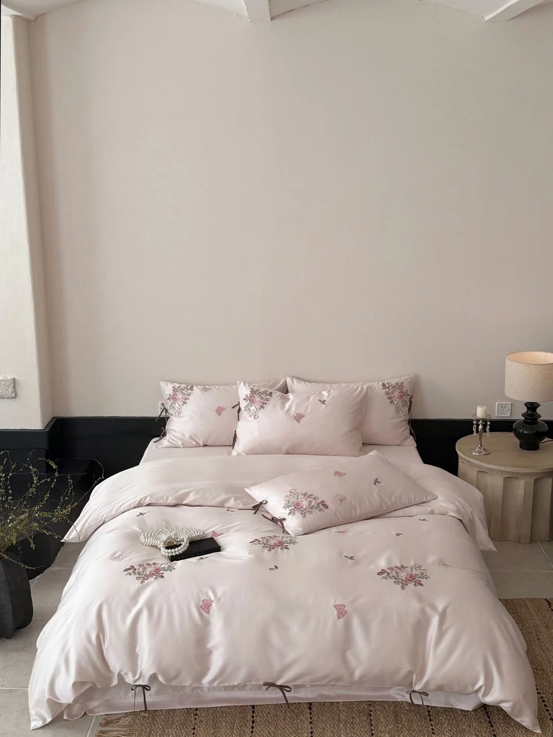 Fine satin bedding set with floral embroidery, tie ribbons and fine quilted texture Stornfield
