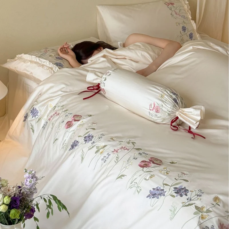Fine satin bed linen set with delicate botanical embroidery and ruffled edge Stornfield