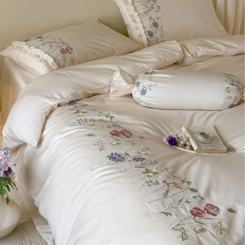 Fine satin bed linen set with delicate botanical embroidery and ruffled edge Stornfield