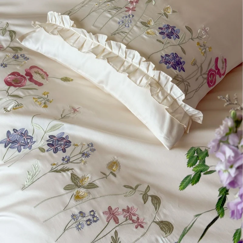 Fine satin bed linen set with delicate botanical embroidery and ruffled edge Stornfield
