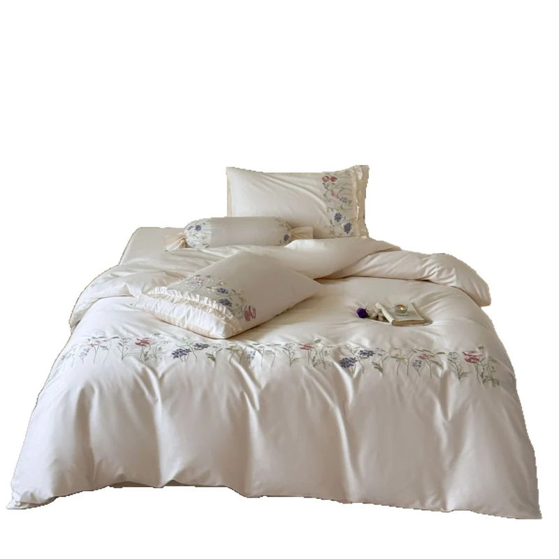 Fine satin bed linen set with delicate botanical embroidery and ruffled edge Stornfield