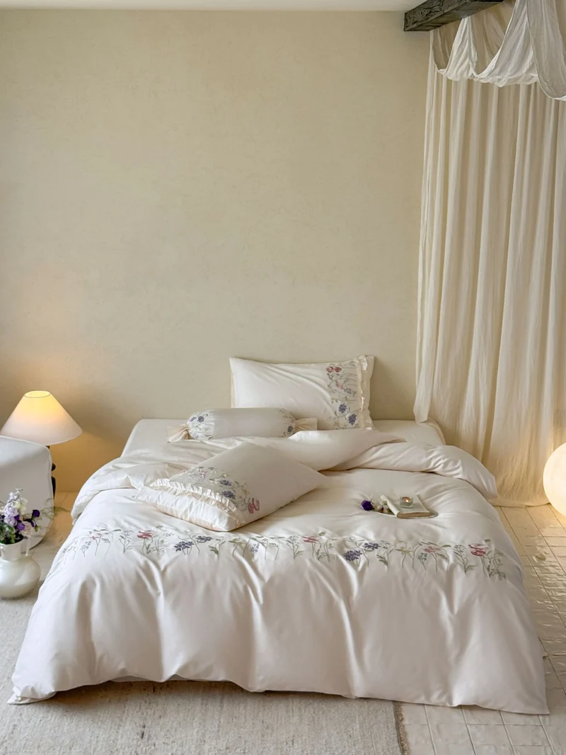 Fine satin bed linen set with delicate botanical embroidery and ruffled edge Stornfield
