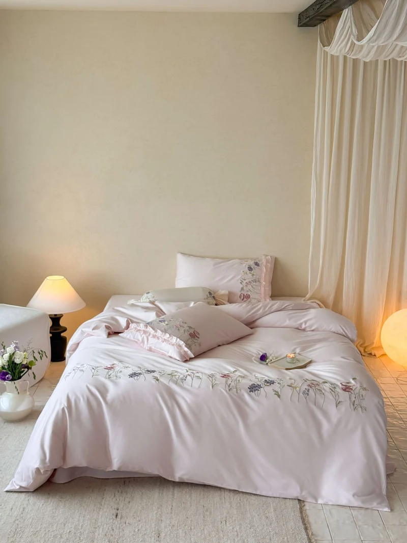 Fine satin bed linen set with delicate botanical embroidery and ruffled edge Stornfield