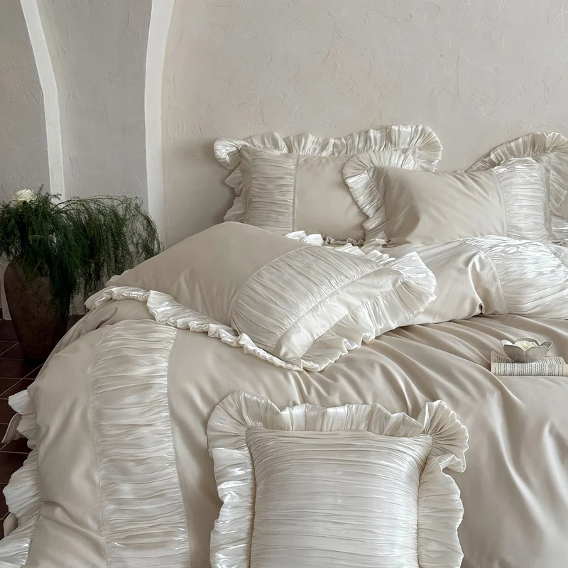 Elegant satin bed linen set with pleated inserts, ruffled edges and decorative cushions Stornfield