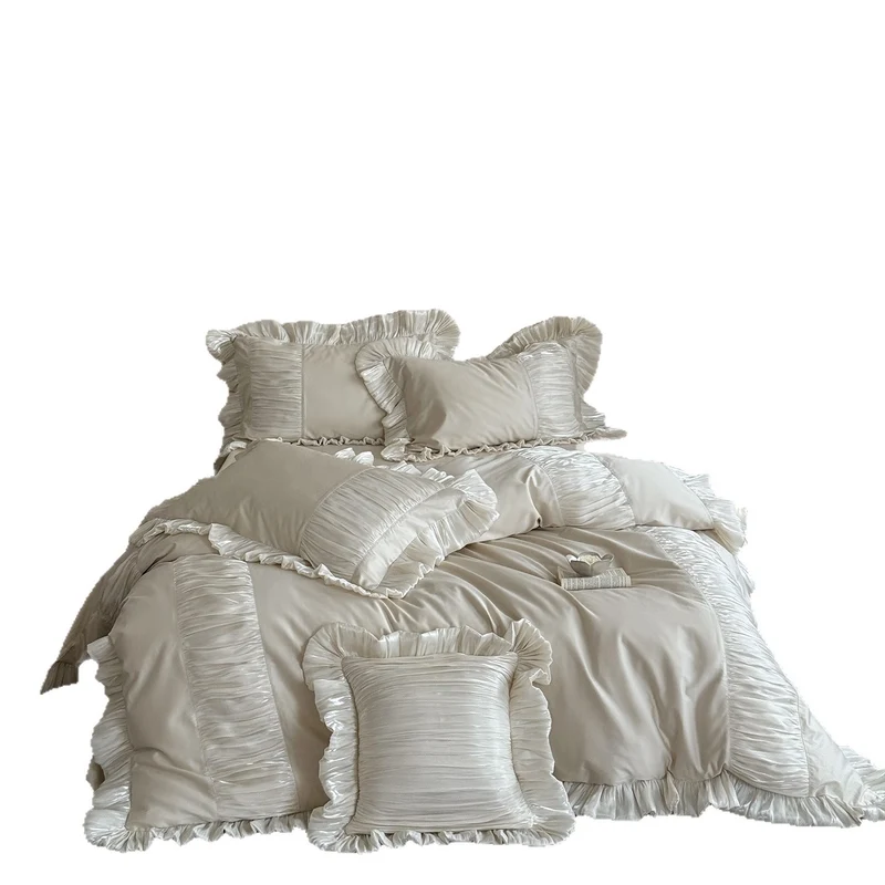 Elegant satin bed linen set with pleated inserts, ruffled edges and decorative cushions Stornfield