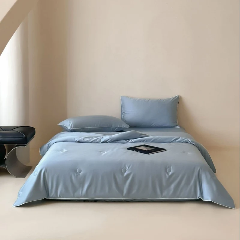 Elegant quilted satin bedspread set with piping and decorative buttons Stornfield