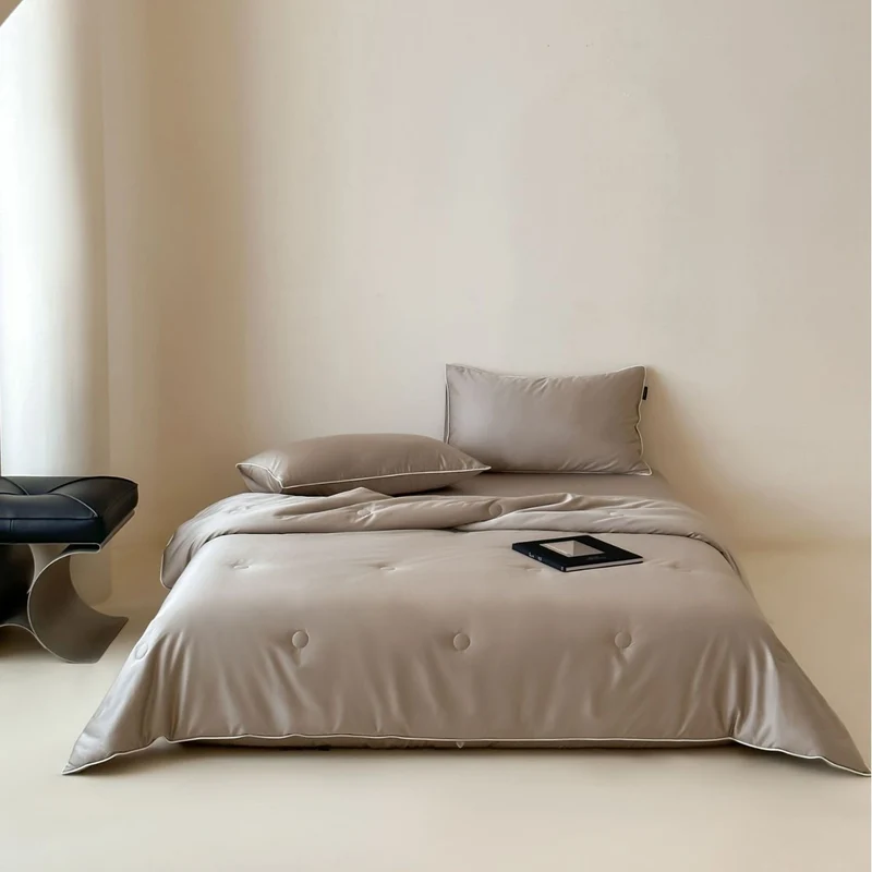 Elegant quilted satin bedspread set with piping and decorative buttons Stornfield