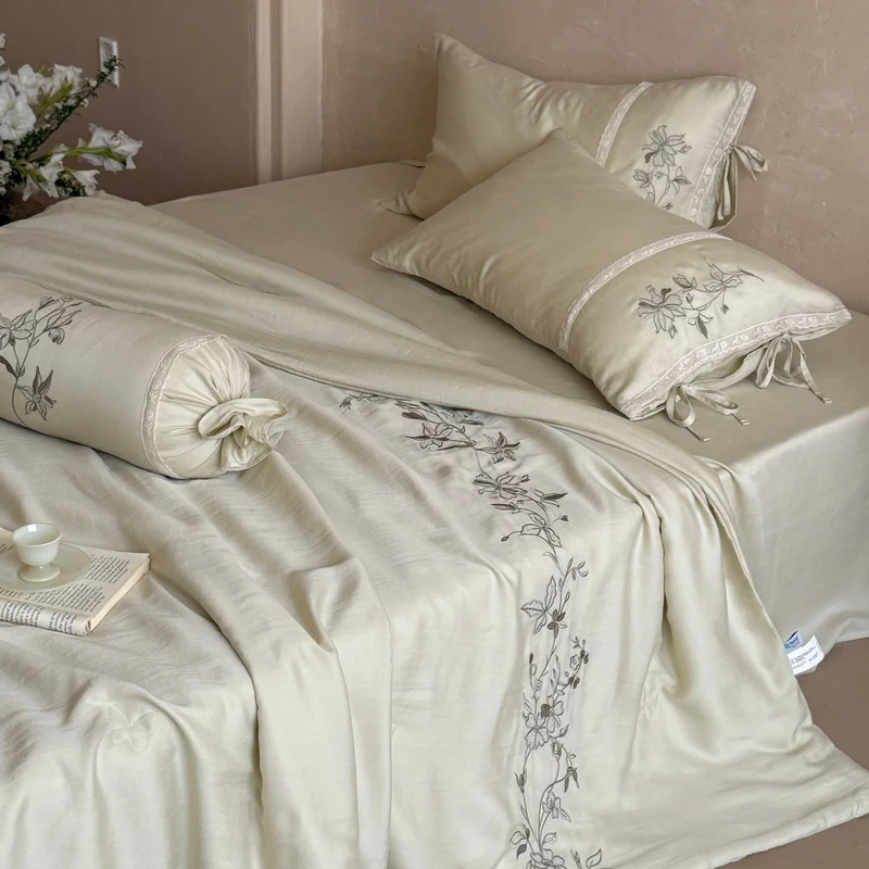 Elegant bedding set made of cotton satin with floral embroidered border and decorative roll cushion Stornfield