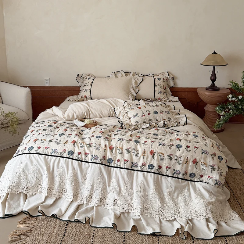 Boho bedding set with embroidered floral pattern and ruffled pillow Stornfield