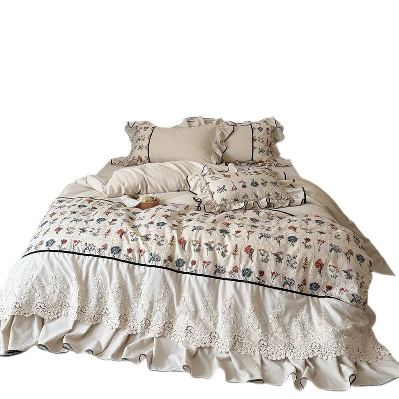Boho bedding set with embroidered floral pattern and ruffled pillow Stornfield