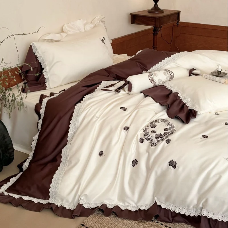 Luxurious embroidered bedding set with ruffle and decorative roll Stornfield