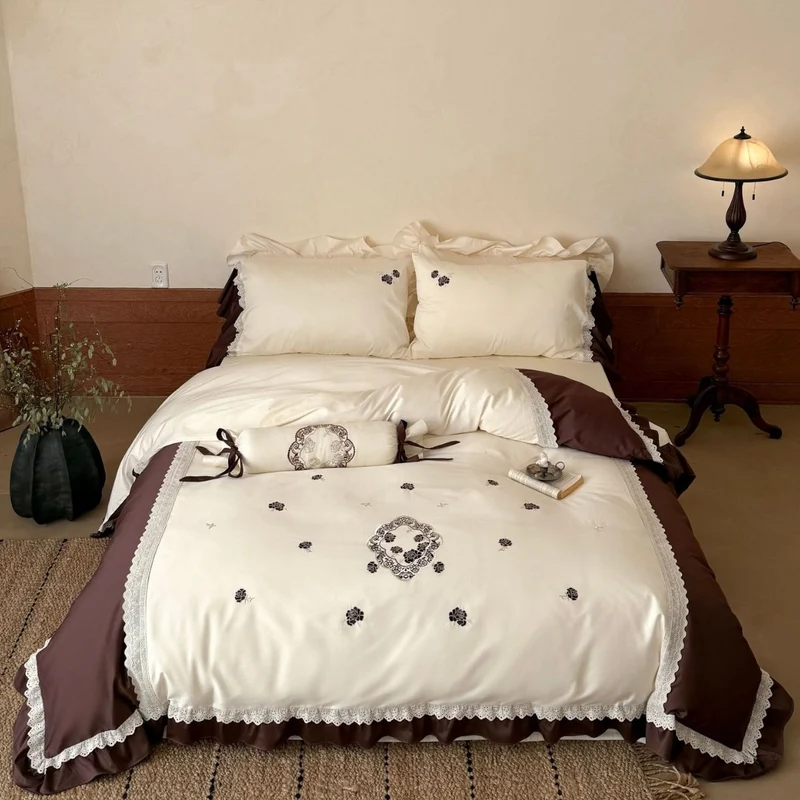 Luxurious embroidered bedding set with ruffle and decorative roll Stornfield