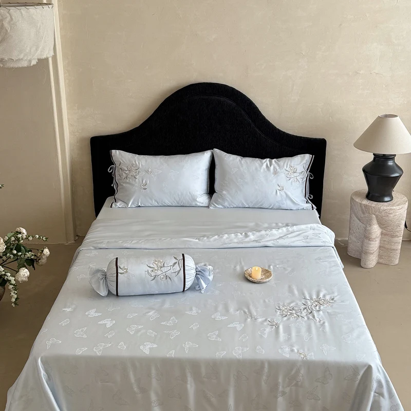 Light jacquard satin bed linen set with embroidered butterfly motif and decorative roll Stornfield