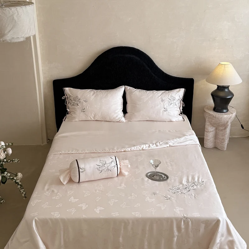 Light jacquard satin bed linen set with embroidered butterfly motif and decorative roll Stornfield