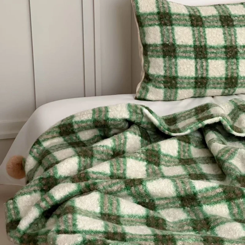 Cuddly blanket with checked pattern and pompom decoration Stornfield