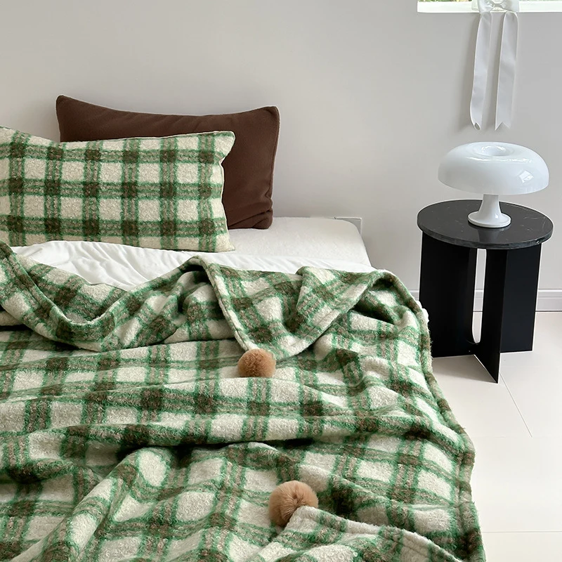 Cuddly blanket with checked pattern and pompom decoration Stornfield
