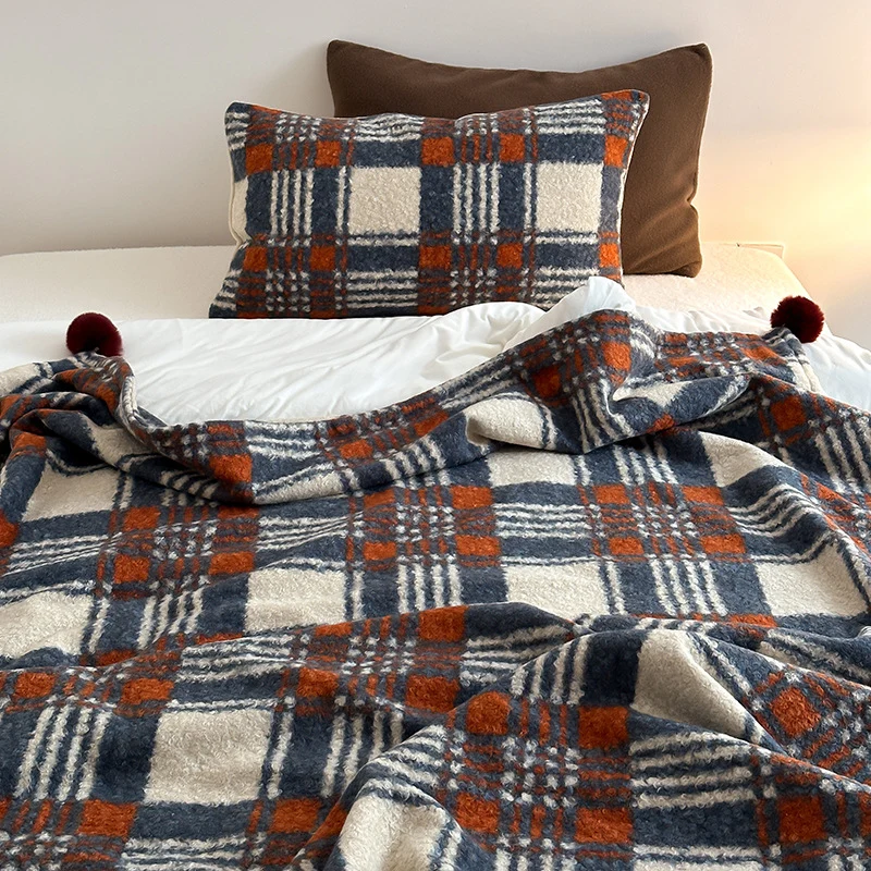 Cuddly blanket with checked pattern and pompom decoration Stornfield
