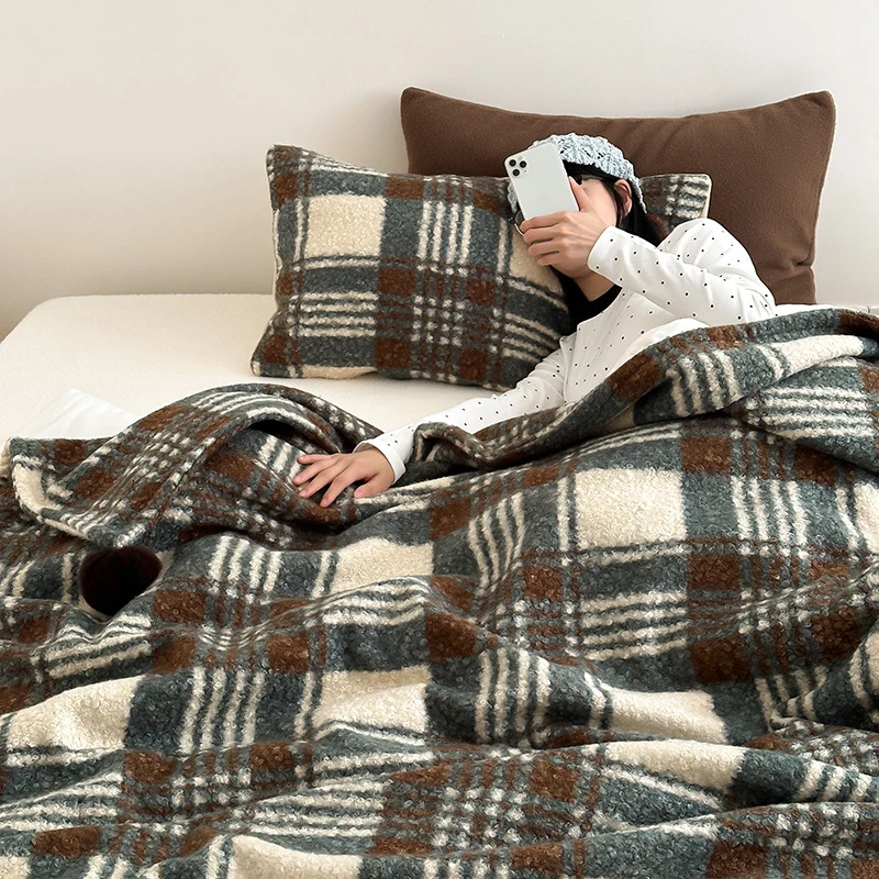 Cuddly blanket with checked pattern and pompom decoration Stornfield