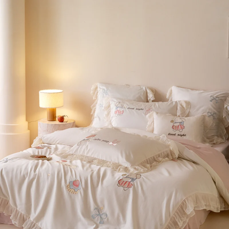 Playful cotton satin bed linen set with ruffled hem and detailed embroidery Stornfield