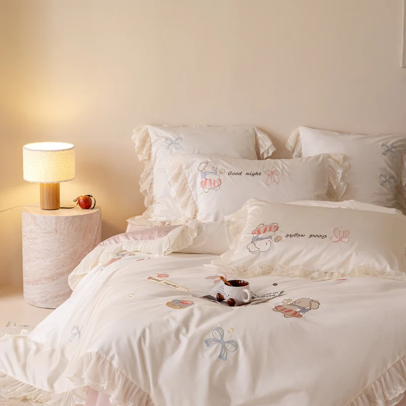 Playful cotton satin bed linen set with ruffled hem and detailed embroidery Stornfield
