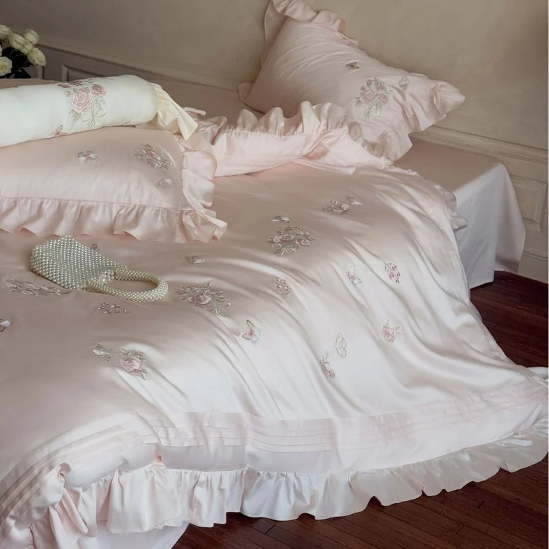 Romantic satin duvet cover set with ruffled trim, rose embroidery, and decorative pillow Stornfield