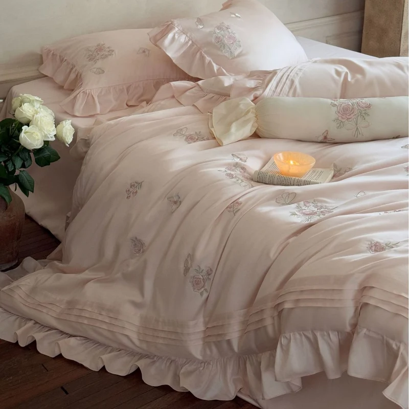 Romantic satin duvet cover set with ruffled trim, rose embroidery, and decorative pillow Stornfield