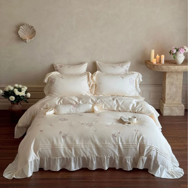 Romantic satin duvet cover set with ruffled trim, rose embroidery, and decorative pillow Stornfield