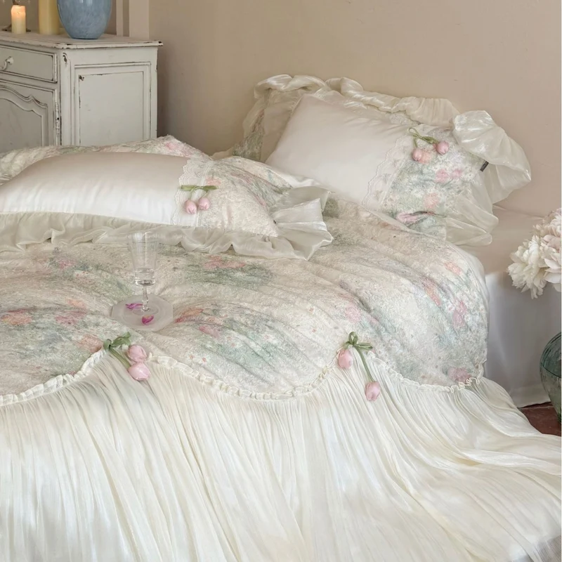 Romantic bedding set with ruffled frill, embroidered decorative pillows, and flowing pleated bedspread Stornfield