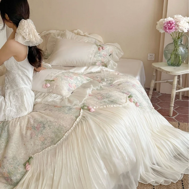 Romantic bedding set with ruffled frill, embroidered decorative pillows, and flowing pleated bedspread Stornfield