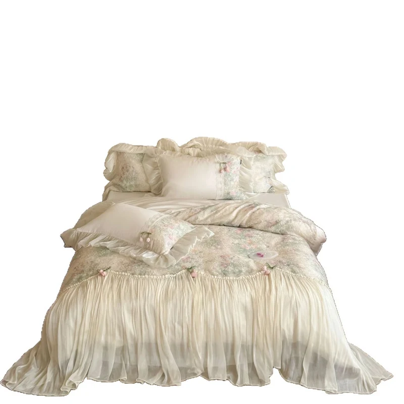 Romantic bedding set with ruffled frill, embroidered decorative pillows, and flowing pleated bedspread Stornfield