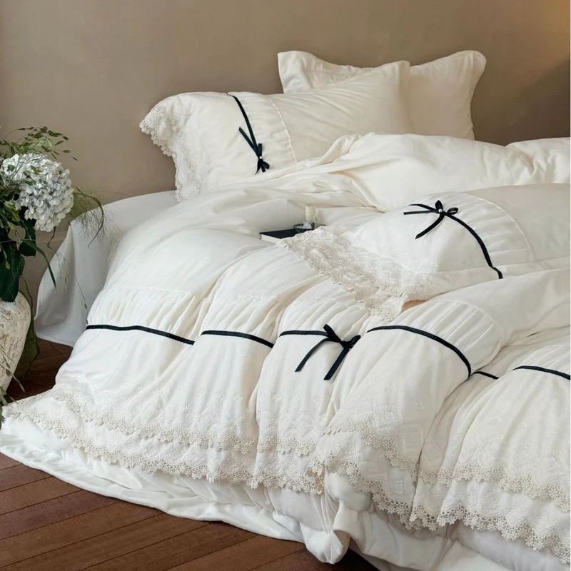 Romantic cotton satin bed linen set with ruffled hem, lace trim and decorative ribbons Stornfield
