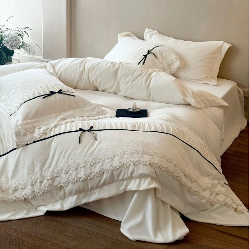 Romantic cotton satin bed linen set with ruffled hem, lace trim and decorative ribbons Stornfield